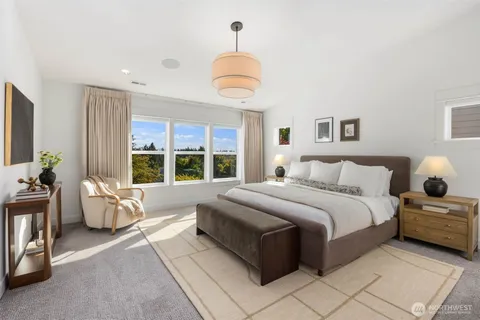 a spacious bedroom with a bed and a chandelier