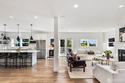 a living room with lots of furniture and kitchen view