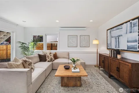 a living room with furniture and a wooden floor