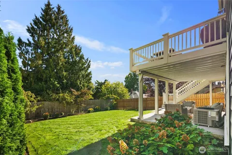 a view of a house with a yard and deck