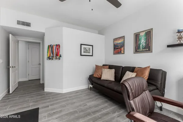 a living room with furniture and a wooden floor