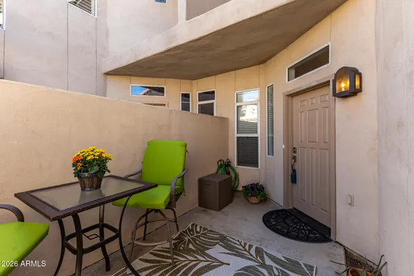 a view of a chairs and table in backyard