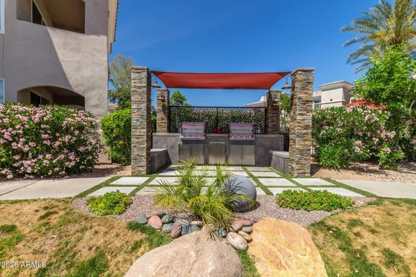 a view of a patio with a table and chairs under an umbrella