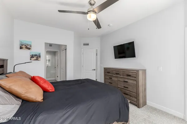 a bedroom with a large bed and a window