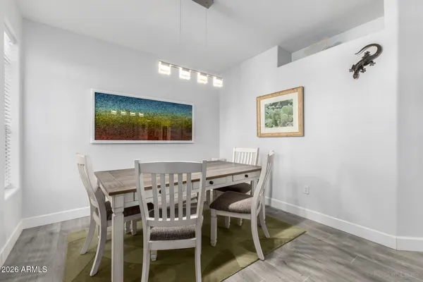 a view of a dining room with furniture and wooden floor