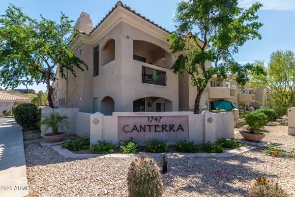 a front view of a house with a yard and a garden