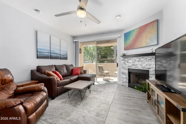 a living room with furniture and a fireplace