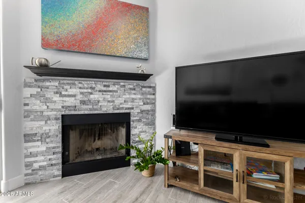 a living room with a fireplace and a flat screen tv