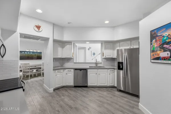 a kitchen with stainless steel appliances a refrigerator sink and stove top oven