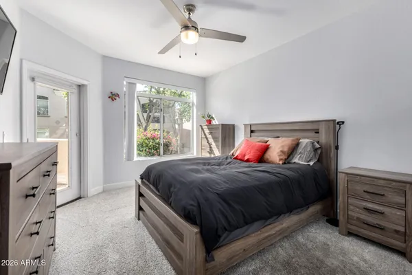 a bed sitting in a bedroom next to a window