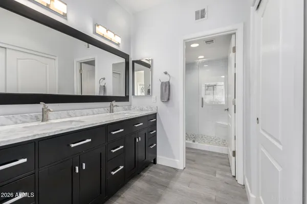 a spacious bathroom with a double vanity sink mirror and double