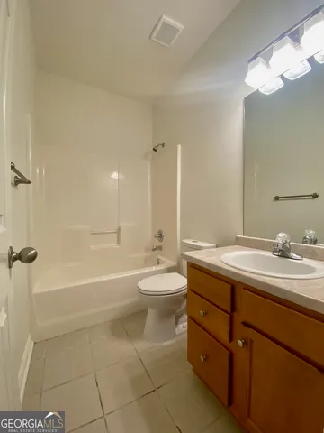 a bathroom with a double vanity sink toilet mirror and bathtub