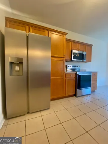 a kitchen with stainless steel appliances granite countertop a refrigerator and a stove