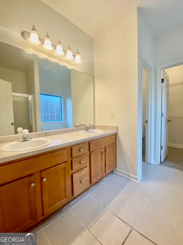 a spacious bathroom with a double vanity sink mirror and