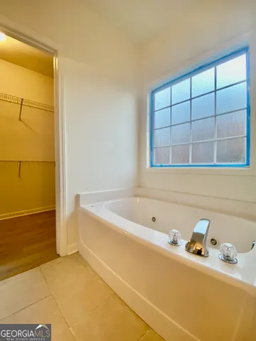a bathroom with a tub and sink