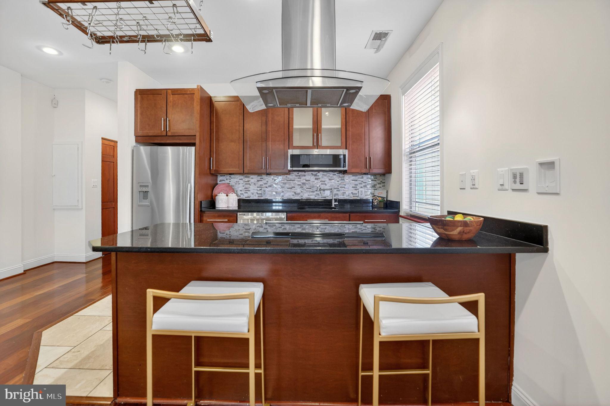 3573 Warder Street Northwest, Unit 7 Washington, DC 20010 - Photo 18 of 61 a kitchen with stainless steel appliances a sink and cabinets
