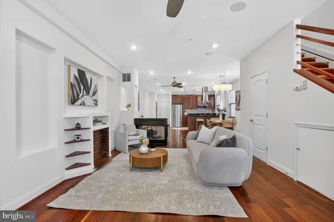 a living room with furniture and kitchen view