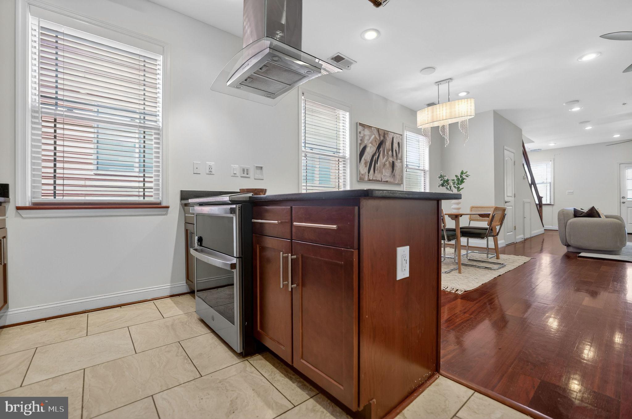 3573 Warder Street Northwest, Unit 7 Washington, DC 20010 - Photo 23 of 61 a kitchen with stainless steel appliances granite countertop a refrigerator a sink a stove and island