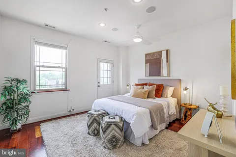 a bed room with a bed mirror and a window