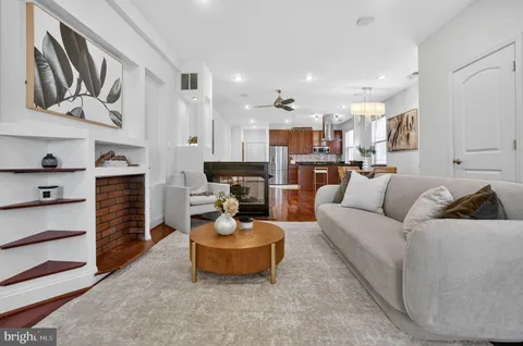 a living room with furniture and a kitchen
