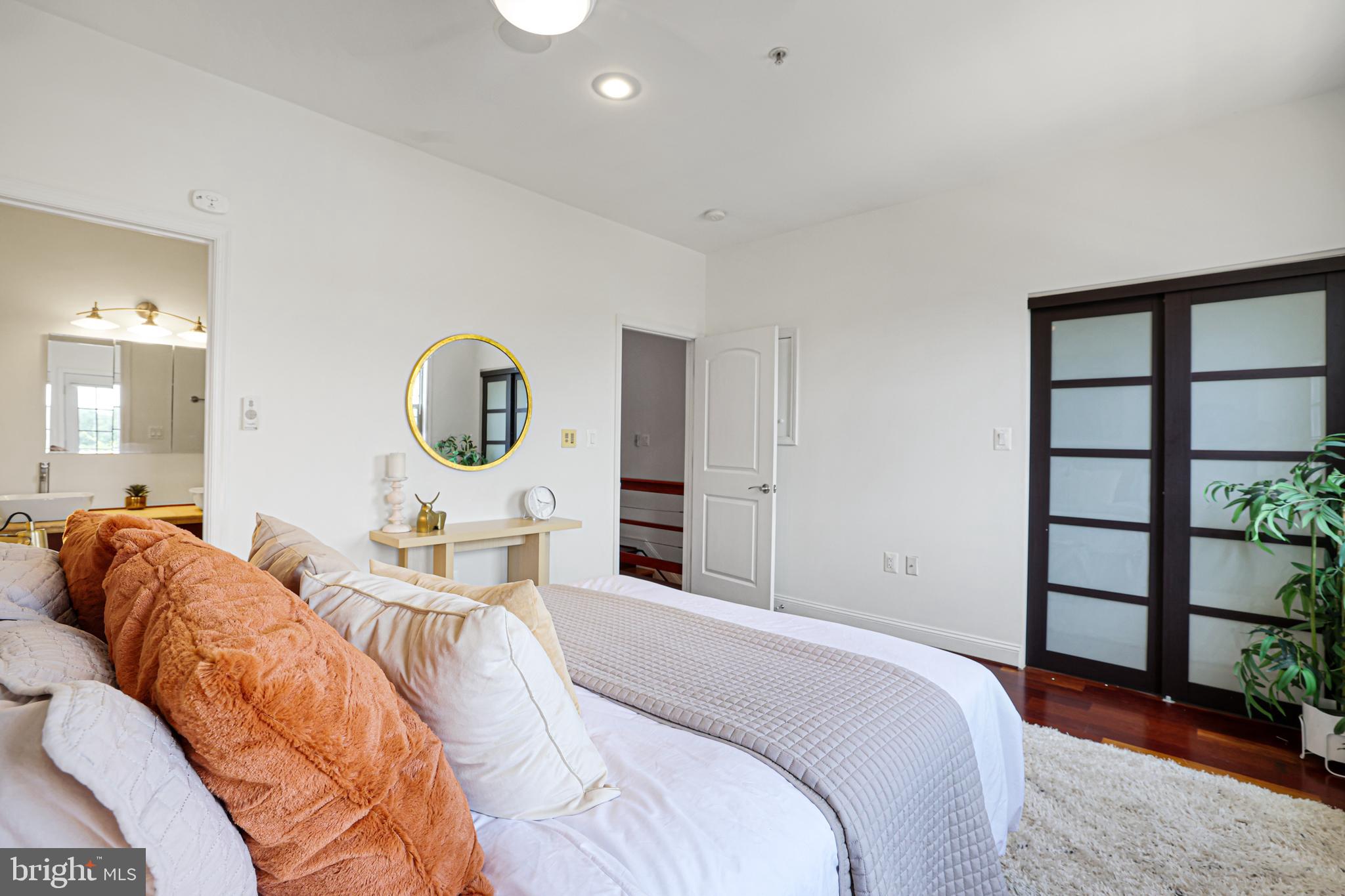 3573 Warder Street Northwest, Unit 7 Washington, DC 20010 - Photo 32 of 61 a bed room with a bed mirror and a window