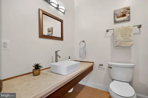 a bathroom with a sink mirror and toilet