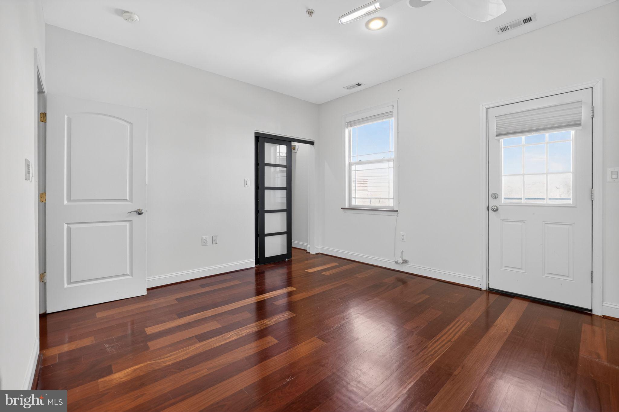 3573 Warder Street Northwest, Unit 7 Washington, DC 20010 - Photo 41 of 61 an empty room with wooden floor and windows