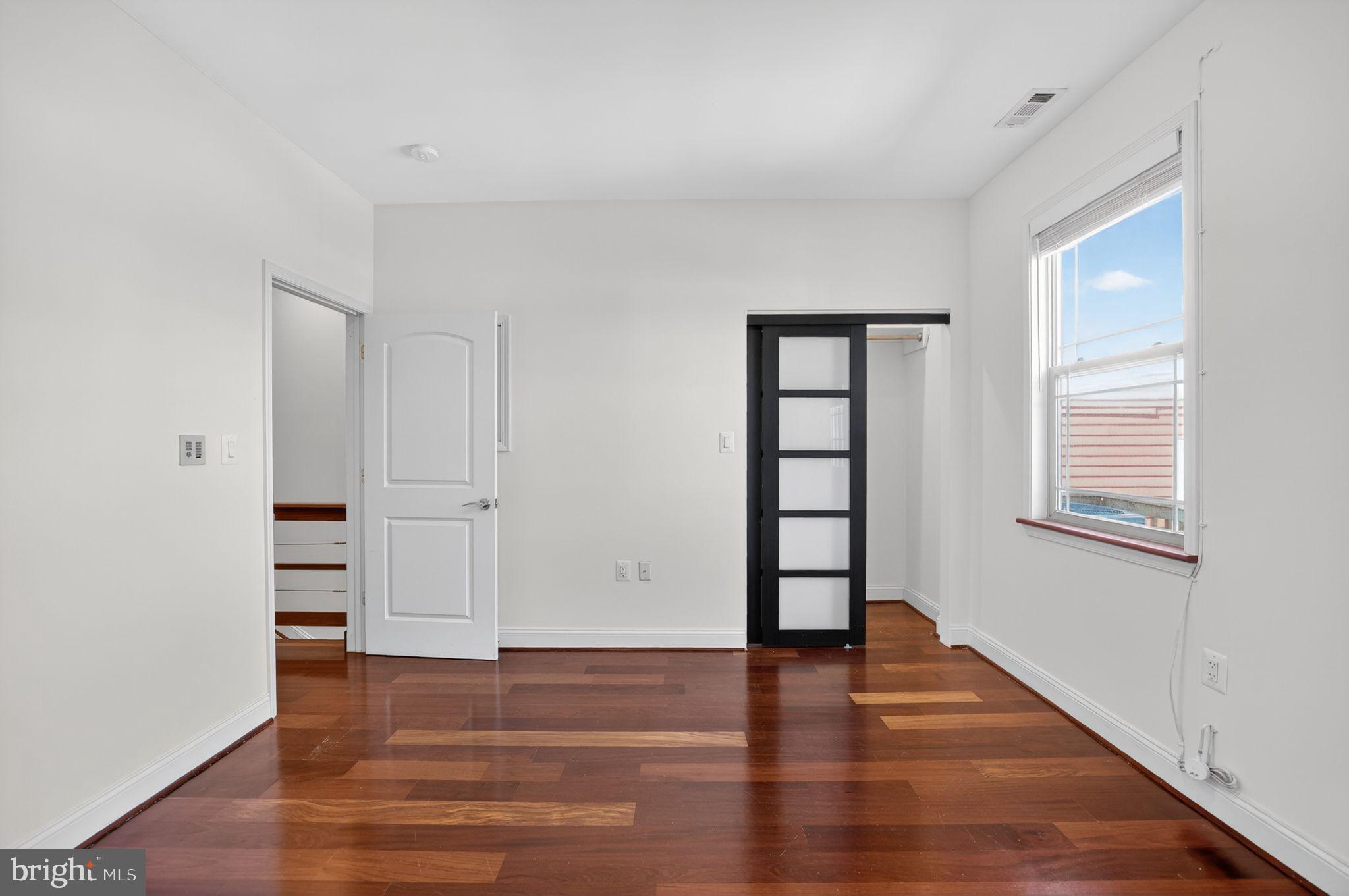 3573 Warder Street Northwest, Unit 7 Washington, DC 20010 - Photo 42 of 61 wooden floor in an empty room with a window