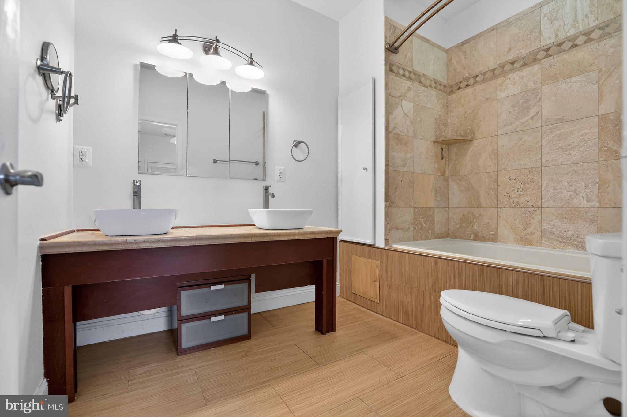 3573 Warder Street Northwest, Unit 7 Washington, DC 20010 - Photo 46 of 61 a bathroom with a sink a toilet and bathtub