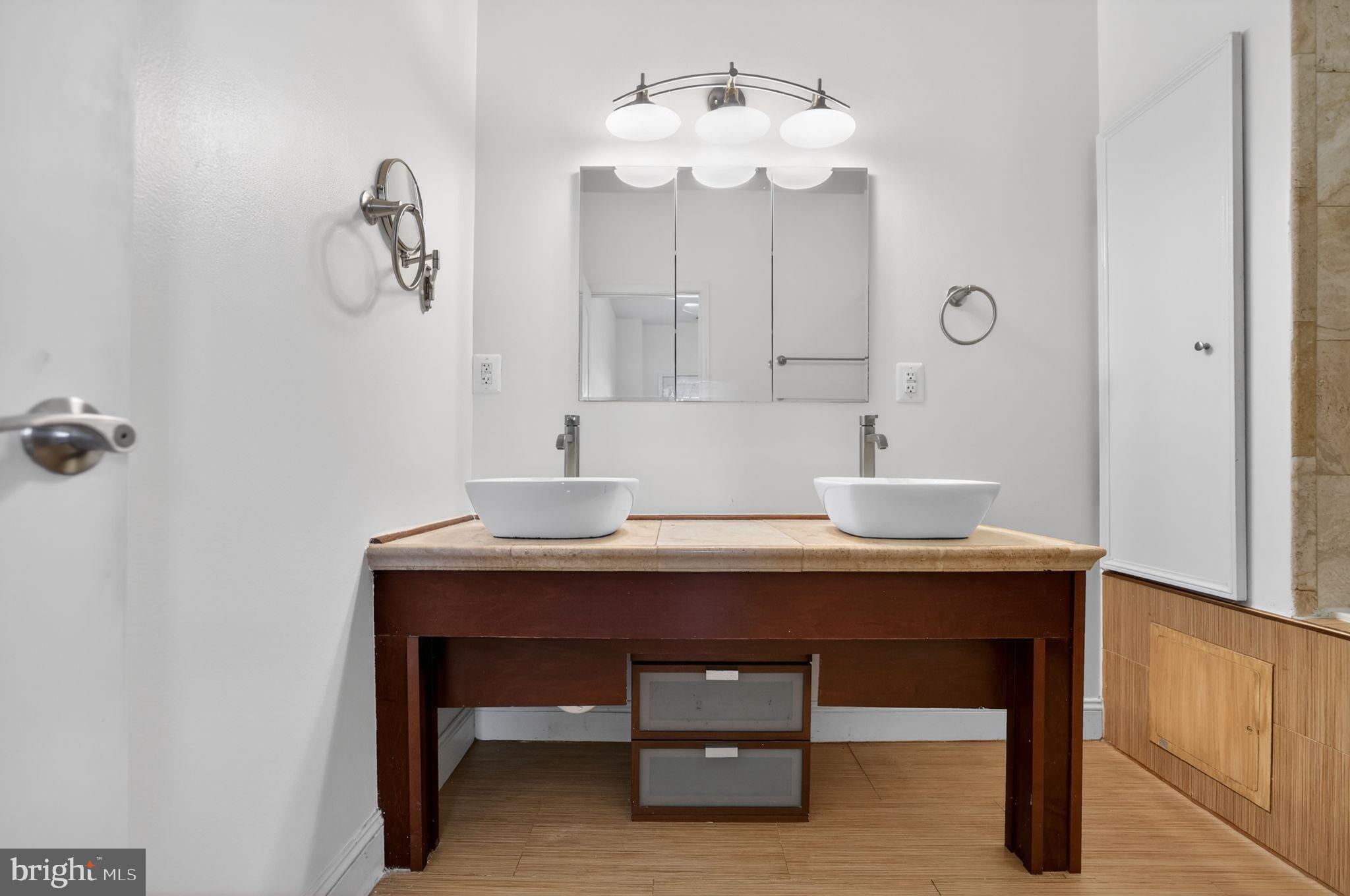 3573 Warder Street Northwest, Unit 7 Washington, DC 20010 - Photo 47 of 61 a view of bathroom with a sink a mirror and a lamp