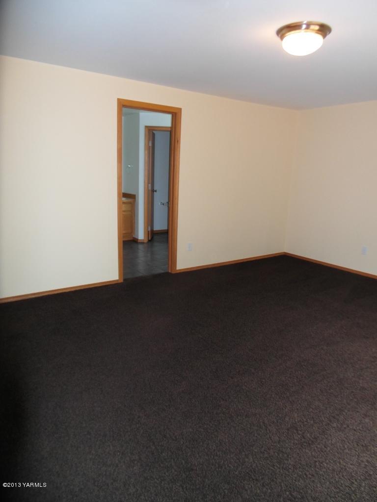 508 Canyon Road Yakima, WA 98901 - Photo 12 of 31 a view of an empty room with wooden floor and a window