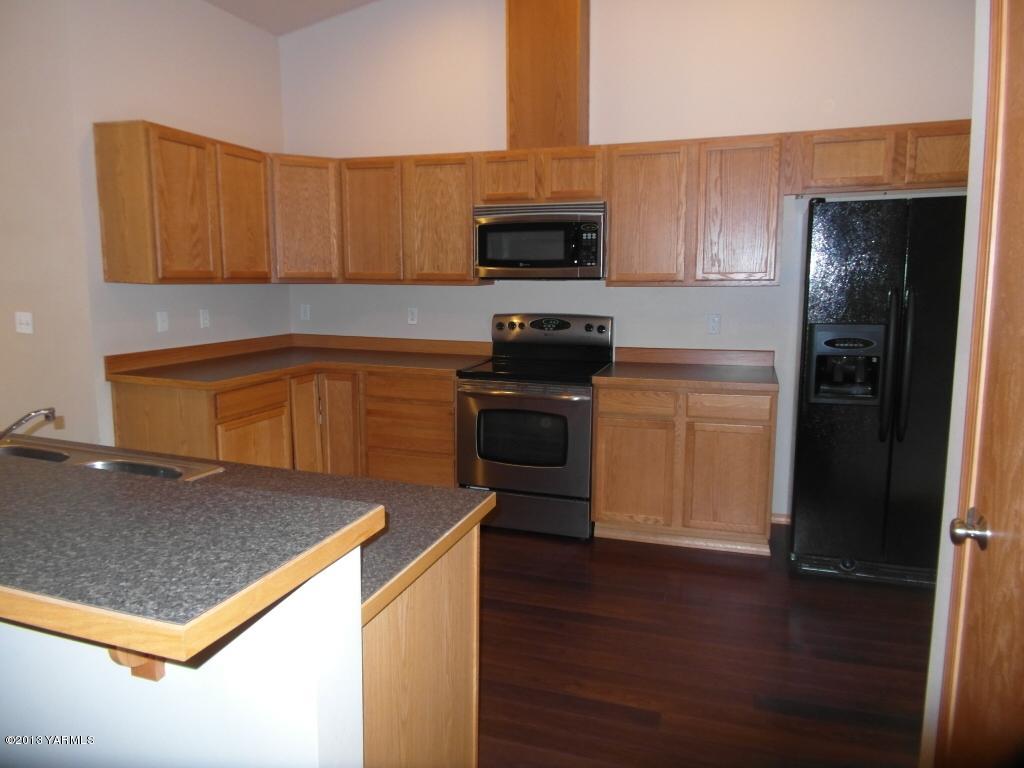 508 Canyon Road Yakima, WA 98901 - Photo 3 of 31 a kitchen with stainless steel appliances granite countertop a refrigerator stove top oven and sink