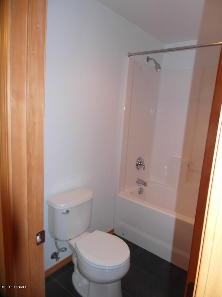 508 Canyon Road Yakima, WA 98901 - Photo 23 of 31 a white toilet sitting next to a bath tub