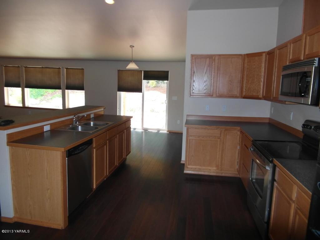 508 Canyon Road Yakima, WA 98901 - Photo 4 of 31 a kitchen with stainless steel appliances a sink stove and microwave