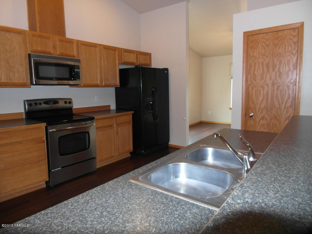 508 Canyon Road Yakima, WA 98901 - Photo 5 of 31 a kitchen with stainless steel appliances granite countertop a stove a microwave and a refrigerator