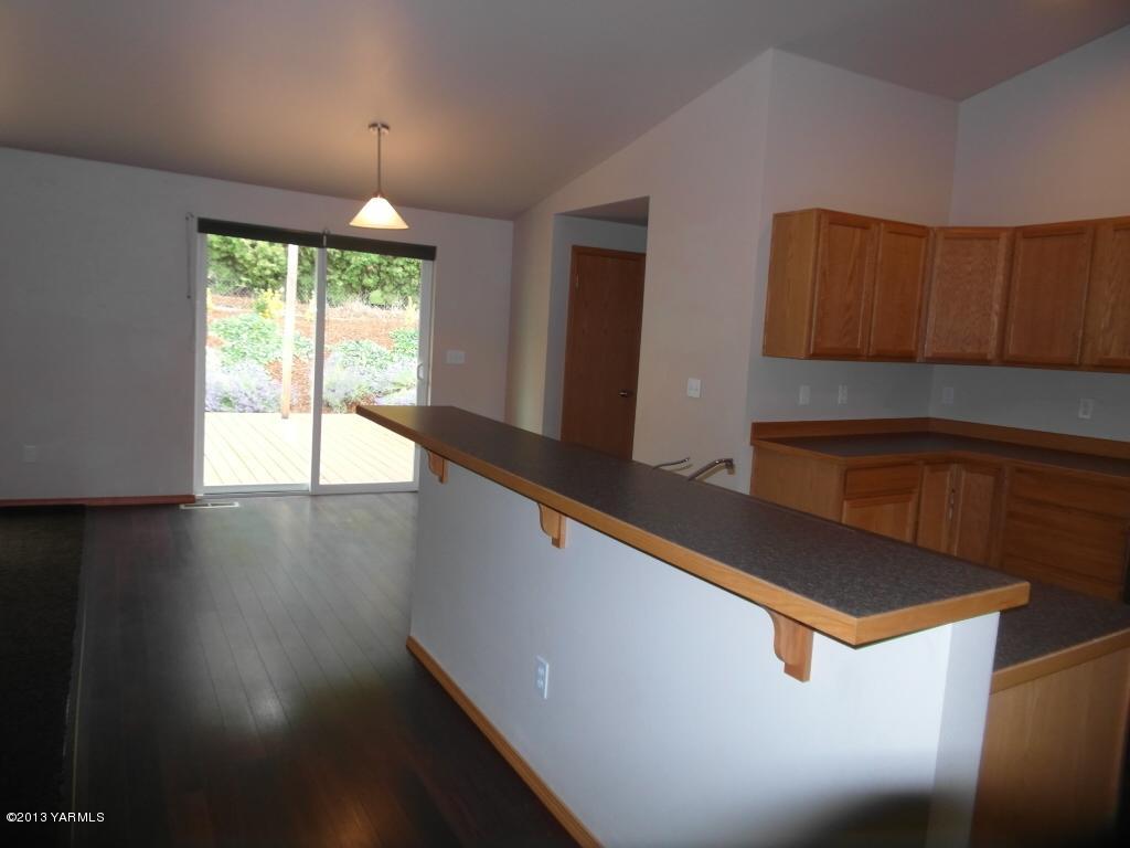 508 Canyon Road Yakima, WA 98901 - Photo 6 of 31 a kitchen with kitchen island a sink wooden floor and a large window