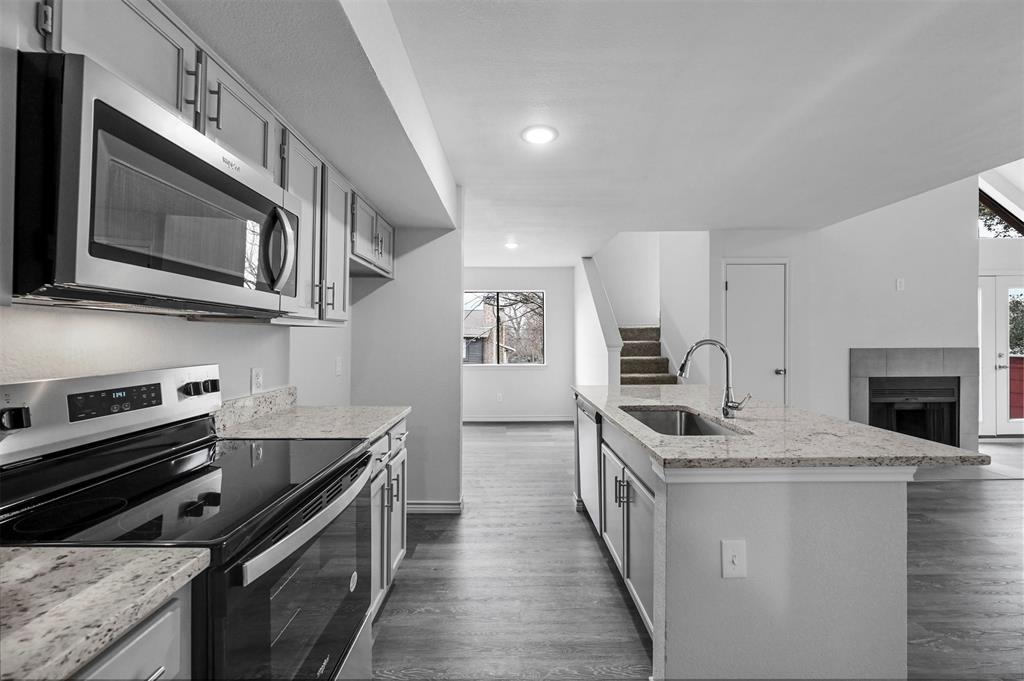 9825 Walnut Street, Unit 206 Dallas, TX 75243 - Photo 17 of 35 a kitchen with stainless steel appliances granite countertop a stove microwave and sink