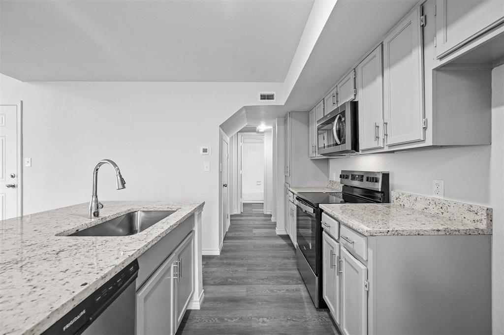 9825 Walnut Street, Unit 206 Dallas, TX 75243 - Photo 18 of 35 a kitchen with stainless steel appliances granite countertop a sink stove and cabinets
