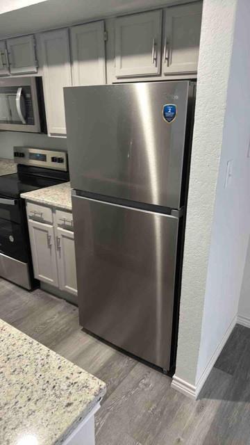 9825 Walnut Street, Unit 206 Dallas, TX 75243 - Photo 21 of 35 a view of a refrigerator in kitchen and an empty room
