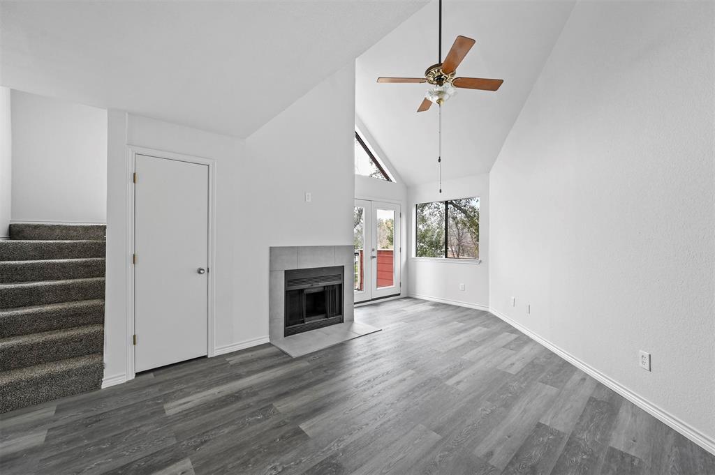9825 Walnut Street, Unit 206 Dallas, TX 75243 - Photo 22 of 35 a view of an empty room with wooden floor fireplace and a window