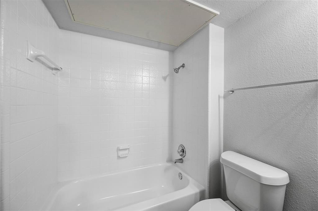 9825 Walnut Street, Unit 206 Dallas, TX 75243 - Photo 25 of 35 a white toilet sitting next to a bath tub