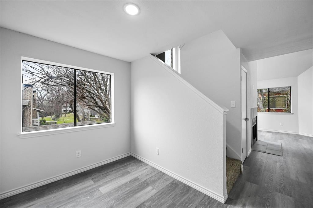 9825 Walnut Street, Unit 206 Dallas, TX 75243 - Photo 28 of 35 a view of an empty room with wooden floor and a window