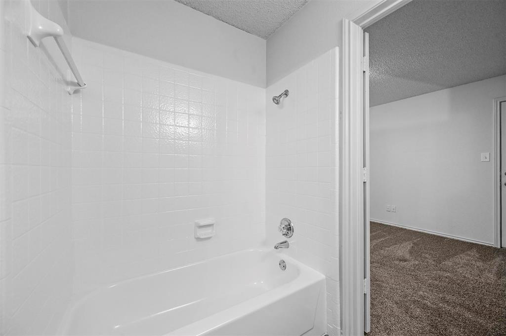 9825 Walnut Street, Unit 206 Dallas, TX 75243 - Photo 32 of 35 a bathroom with a bathtub