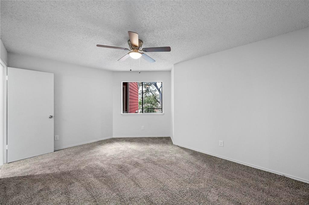 9825 Walnut Street, Unit 206 Dallas, TX 75243 - Photo 33 of 35 an empty room with windows and fan