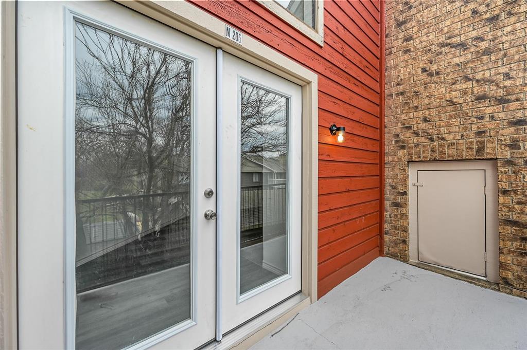 9825 Walnut Street, Unit 206 Dallas, TX 75243 - Photo 34 of 35 a front view of a house with a glass door