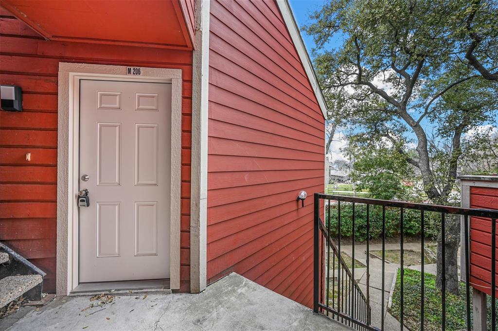 9825 Walnut Street, Unit 206 Dallas, TX 75243 - Photo 4 of 35 a view of a house with a door and wooden walls