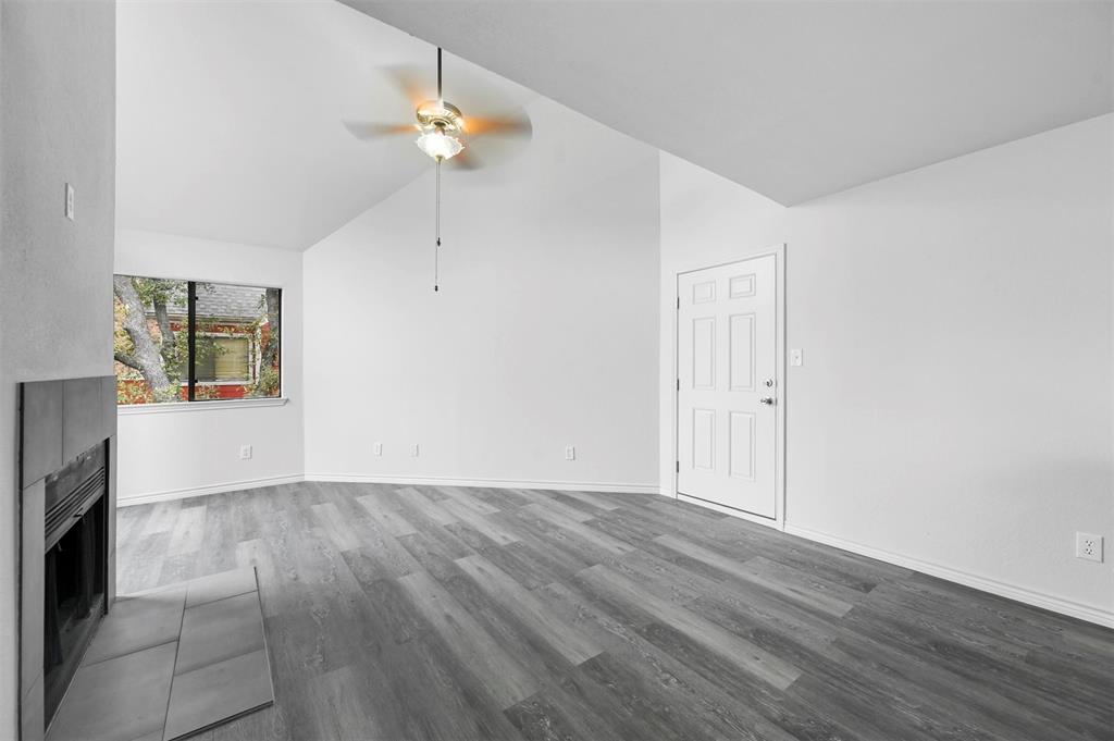 9825 Walnut Street, Unit 206 Dallas, TX 75243 - Photo 8 of 35 a view of wooden floor and a chandelier fan in a room