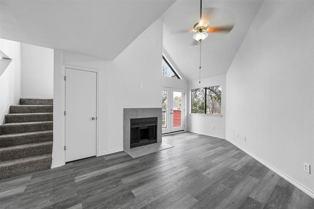 9825 Walnut Street, Unit 206 Dallas, TX 75243 - Photo 9 of 35 a view of an empty room with wooden floor fireplace and a window