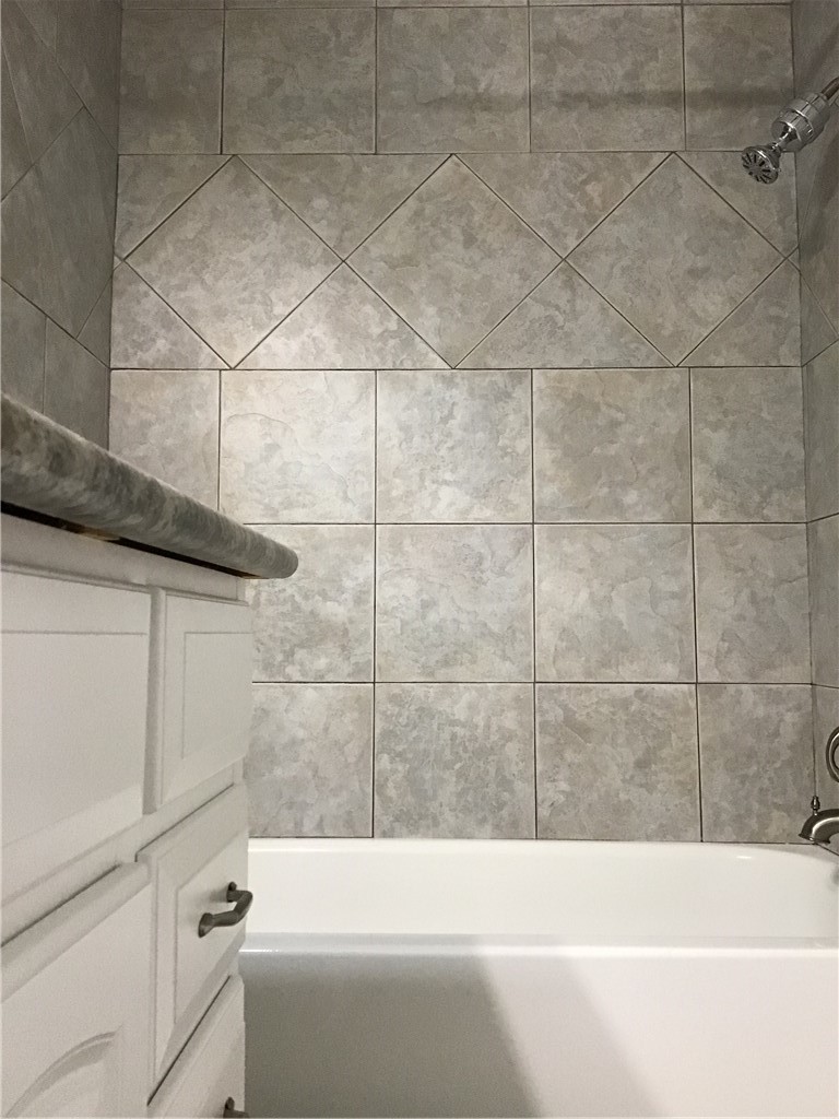 13409 Saddlebrook Trail, Unit A Austin, TX 78729 - Photo 12 of 21 a bathroom with a bathtub and shower