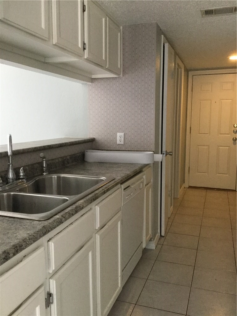 13409 Saddlebrook Trail, Unit A Austin, TX 78729 - Photo 3 of 21 a kitchen with a sink and cabinets